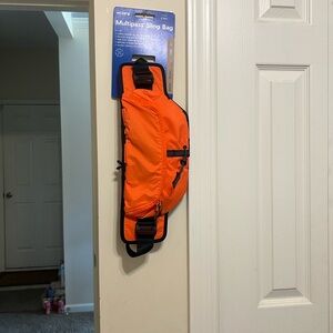 Janji sling bagOrange and Black Padded Strap Accessory with Adjustable Buckle